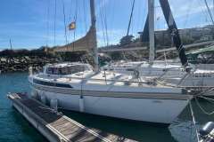 1983 Jeanneau Espace 1000 sailboat docked in a marina, with clear skies.