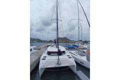 2019 Leopard 45 catamaran docked at marina with cloudy sky backdrop.