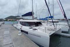 2019 Leopard 45 catamaran docked at marina with scenic background.