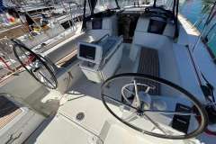 2020 Jeanneau Sun Odyssey 389 cockpit with dual steering wheels and navigation equipment.