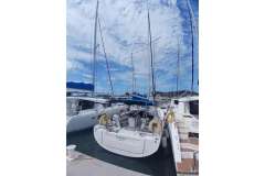 Beneteau Oceanis 46.1 yacht docked at marina, 2020 model, under a partly cloudy sky.