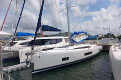 2020 Beneteau Oceanis 46.1 yacht docked at marina under cloudy sky.