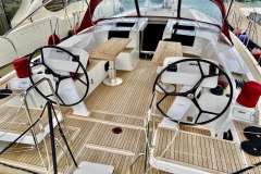 2019 Hanse 508 yacht cockpit with dual steering wheels and wooden deck.