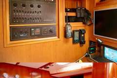 Navigation and control panel inside a 2005 Baltic 60 yacht, featuring modern equipment and wood fini