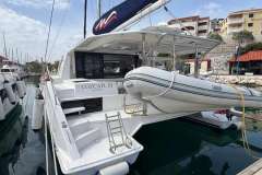Leopard 40 catamaran, 2020 model, docked with dinghy, named Cozcatl III, in a marina setting.
