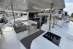Spacious deck of 2020 Leopard 40 catamaran with seating and table.