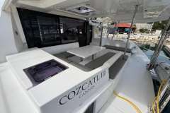 2020 Leopard 40 catamaran with spacious outdoor seating and dining area, docked at a marina.