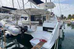 2020 Leopard 40 catamaran docked with inflatable dinghy and outboard motor.