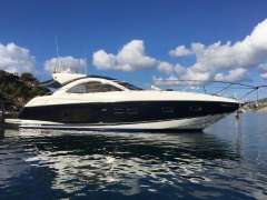 2012 Sunseeker Portofino 48 yacht on calm water under a blue sky.