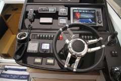 2012 Sunseeker Portofino 48 yacht dashboard with steering wheel and navigation controls.