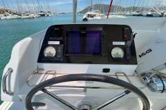Helm of 2020 Lagoon 42 catamaran with navigation instruments and steering wheel.