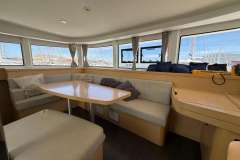 Interior of a 2020 Lagoon 42 catamaran with spacious seating and marina view.