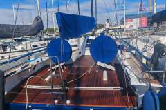 2019 Nautor Swan Club Swan 50 yacht docked, featuring sleek wooden deck and blue covers.