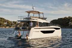 Manufacturer Provided Image: Luxury 2024 Prestige M48 yacht on serene water with people enjoying the