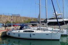 2007 Beneteau Oceanis 40 sailboat docked in a marina under clear blue skies.