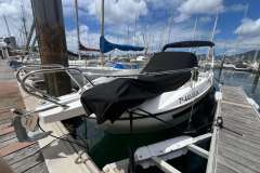 2024 Karnic SL 702 boat docked at marina, covered and ready for sailing.