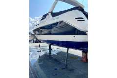 2004 Cranchi Smeraldo 37 yacht on dry dock, showcasing sleek design and blue hull.