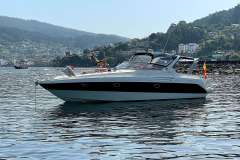 2004 Cranchi Smeraldo 37 yacht anchored in scenic coastal waters.