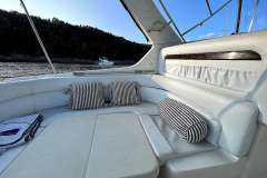 Luxurious interior of 2004 Cranchi Smeraldo 37 yacht with striped cushions.