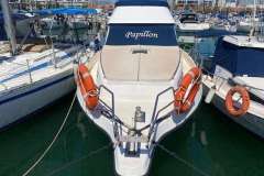 Astinor 1000 boat from 1998, named "Papillon," docked with lifebuoys visible.