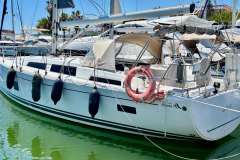 2020 Hanse 388 yacht docked in marina, featuring sleek design and safety equipment.